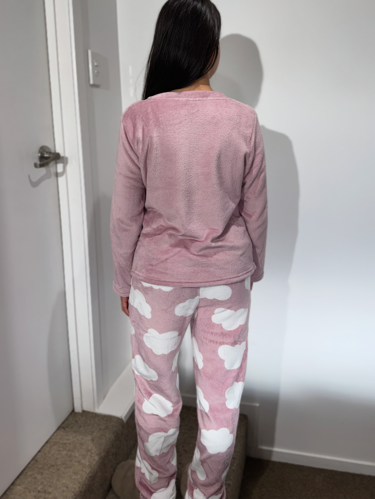 Back view of model wearing the Touch of Heaven sleepwear – soft pink long-sleeve top and printed pants.