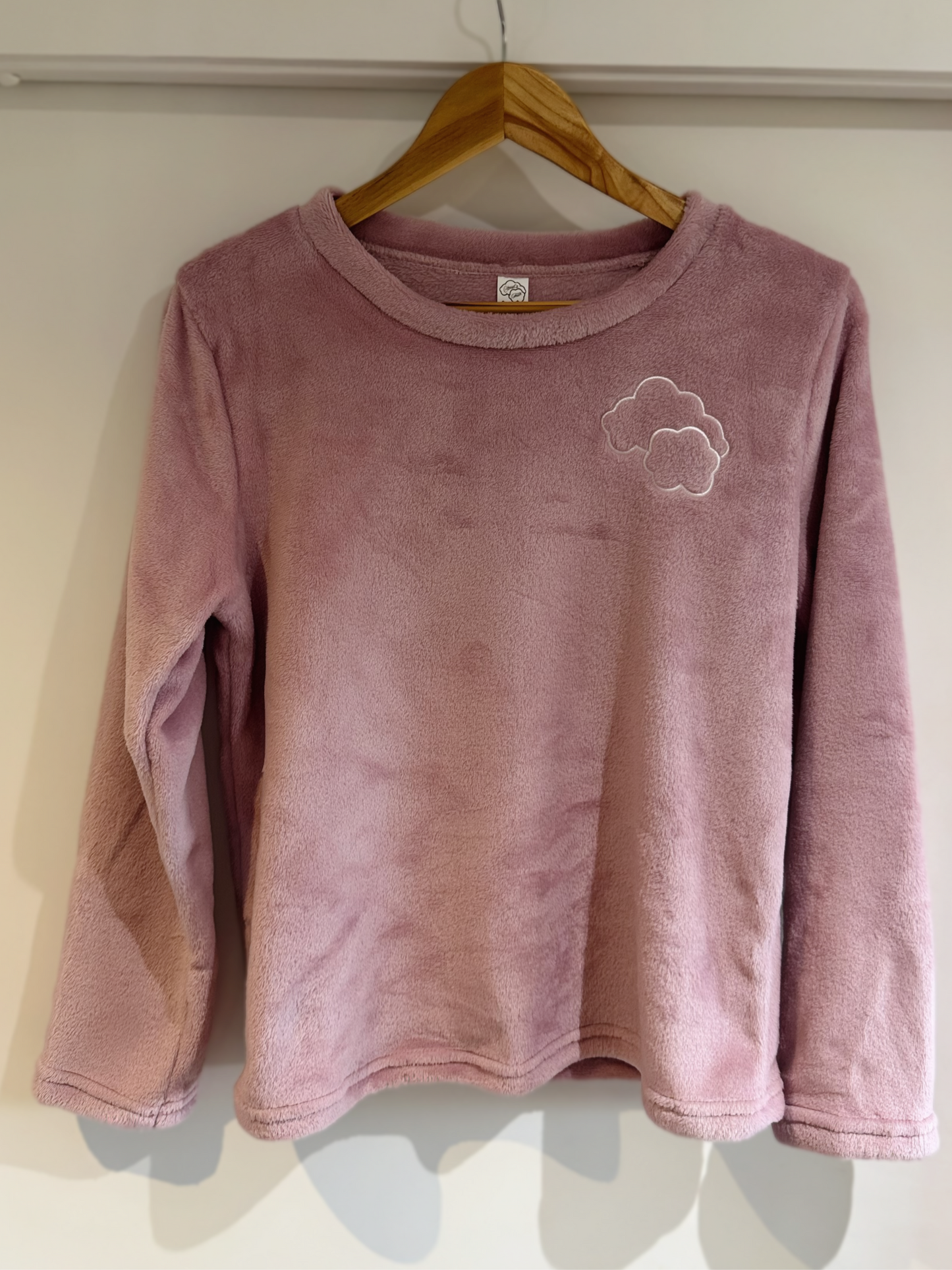 Touch of Heaven long-sleeve pajama top on hanger – soft pink with embroidered cloud detail.