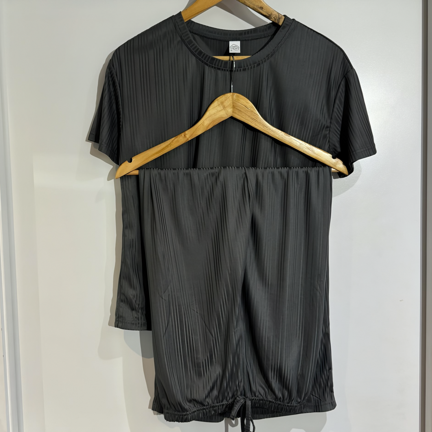 Serene Night pajama set on hanger – soft dark grey fabric with a relaxed-fit t-shirt and pants.