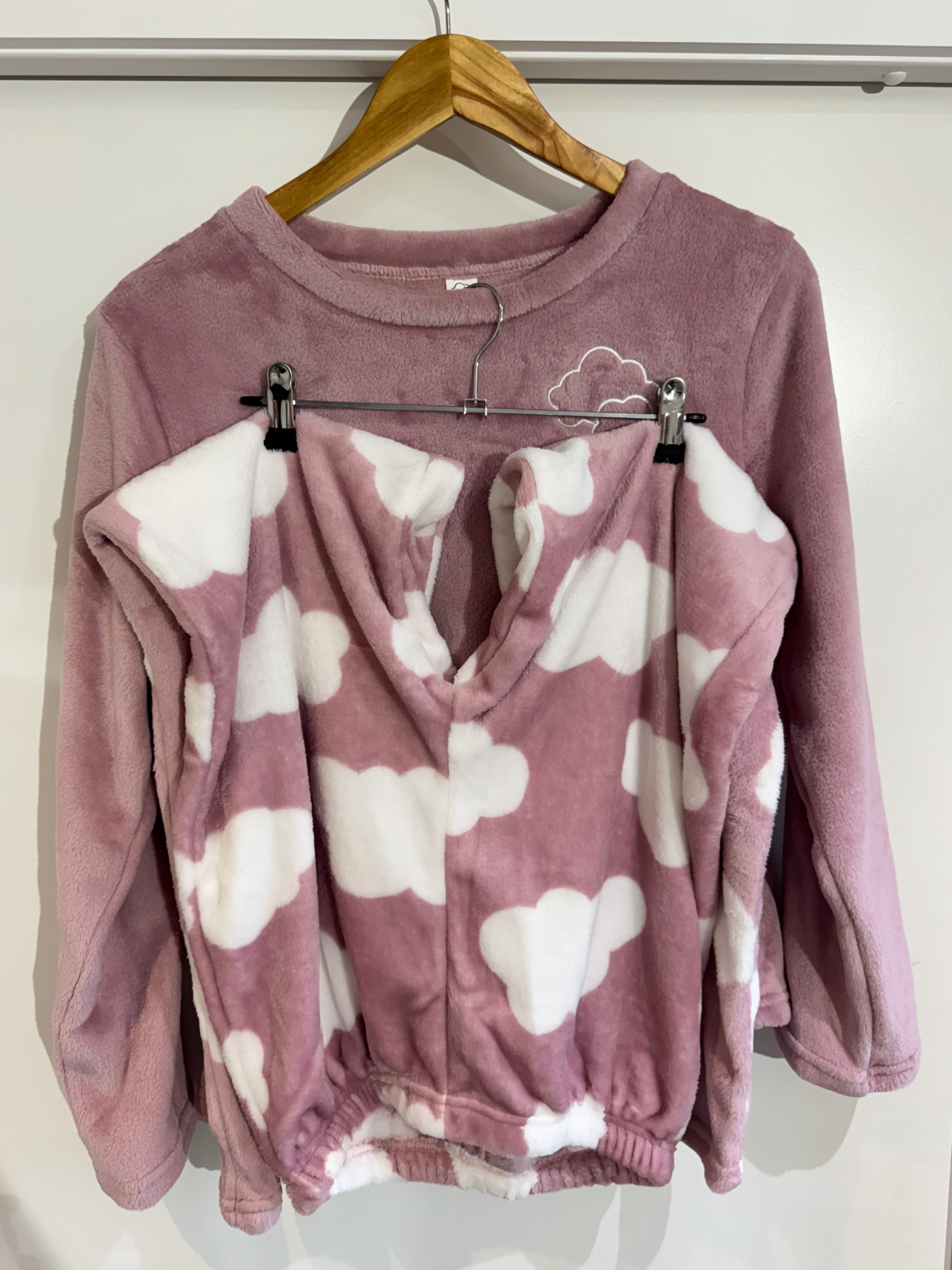 Touch of Heaven pajama set on hanger – long-sleeve top and pants with white cloud print.